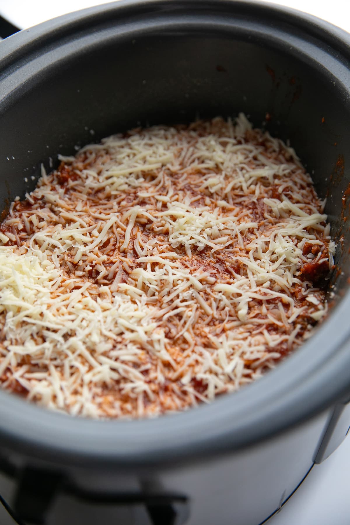 layering lasagna in slow cooker; unbaked crockpot lasagna