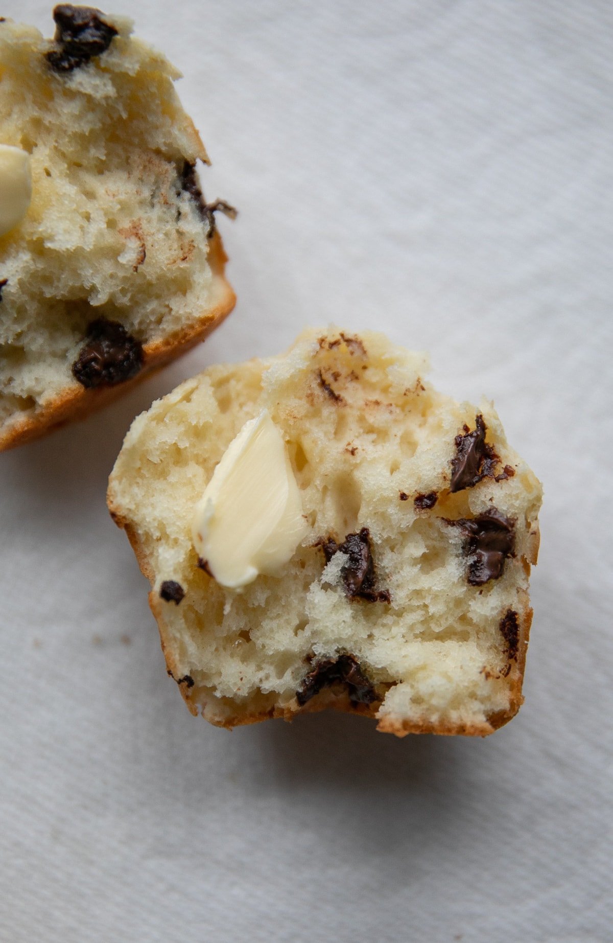 open chocolate chip muffin with butter