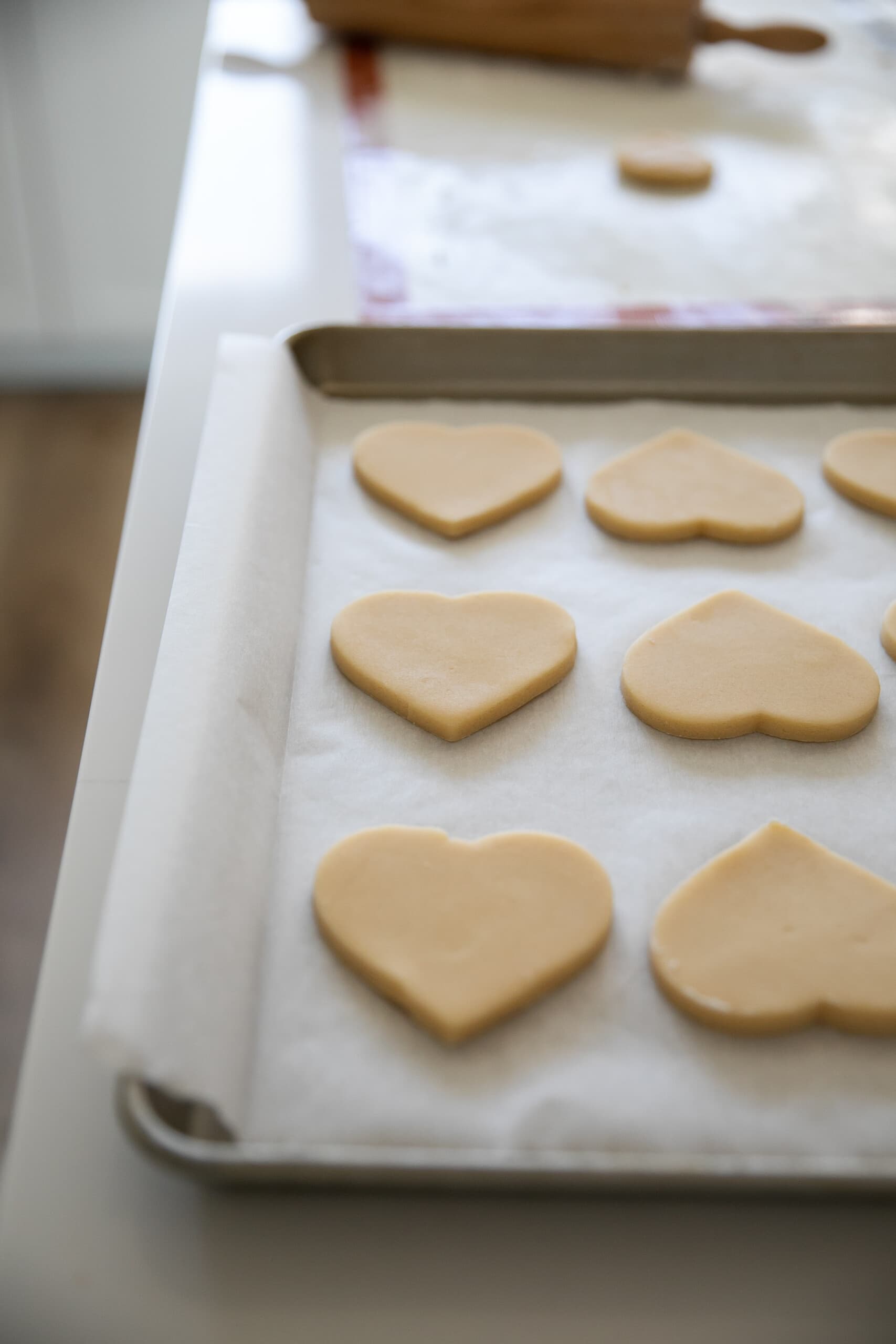 sugar cookie hearts on baking sheet