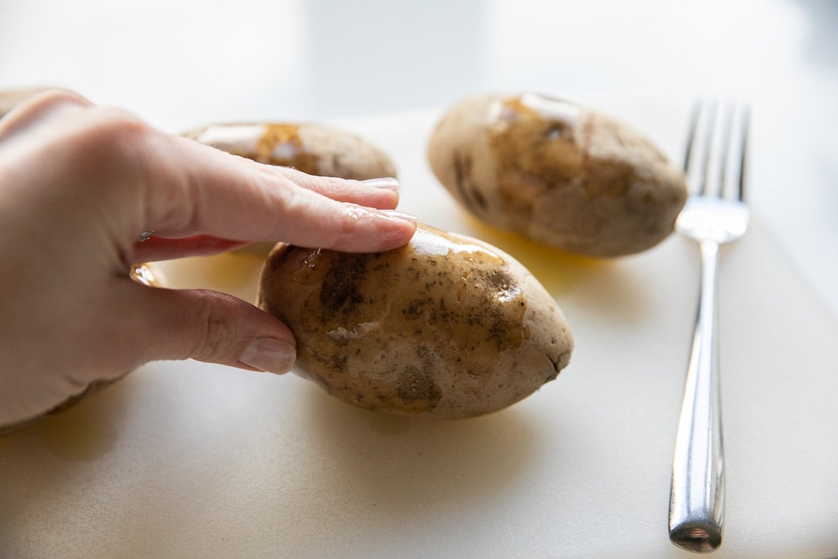 rubbing potatoes with olive oil