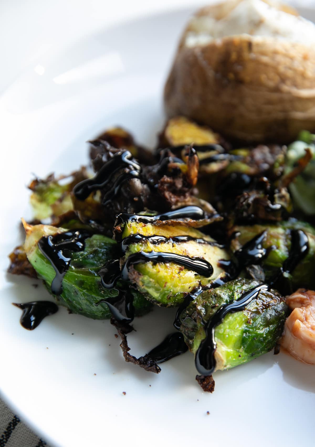 air frier brussels sprouts on plate with balsamic glaze