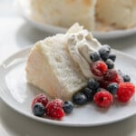 slice of angel food cake with whipped cream and berries