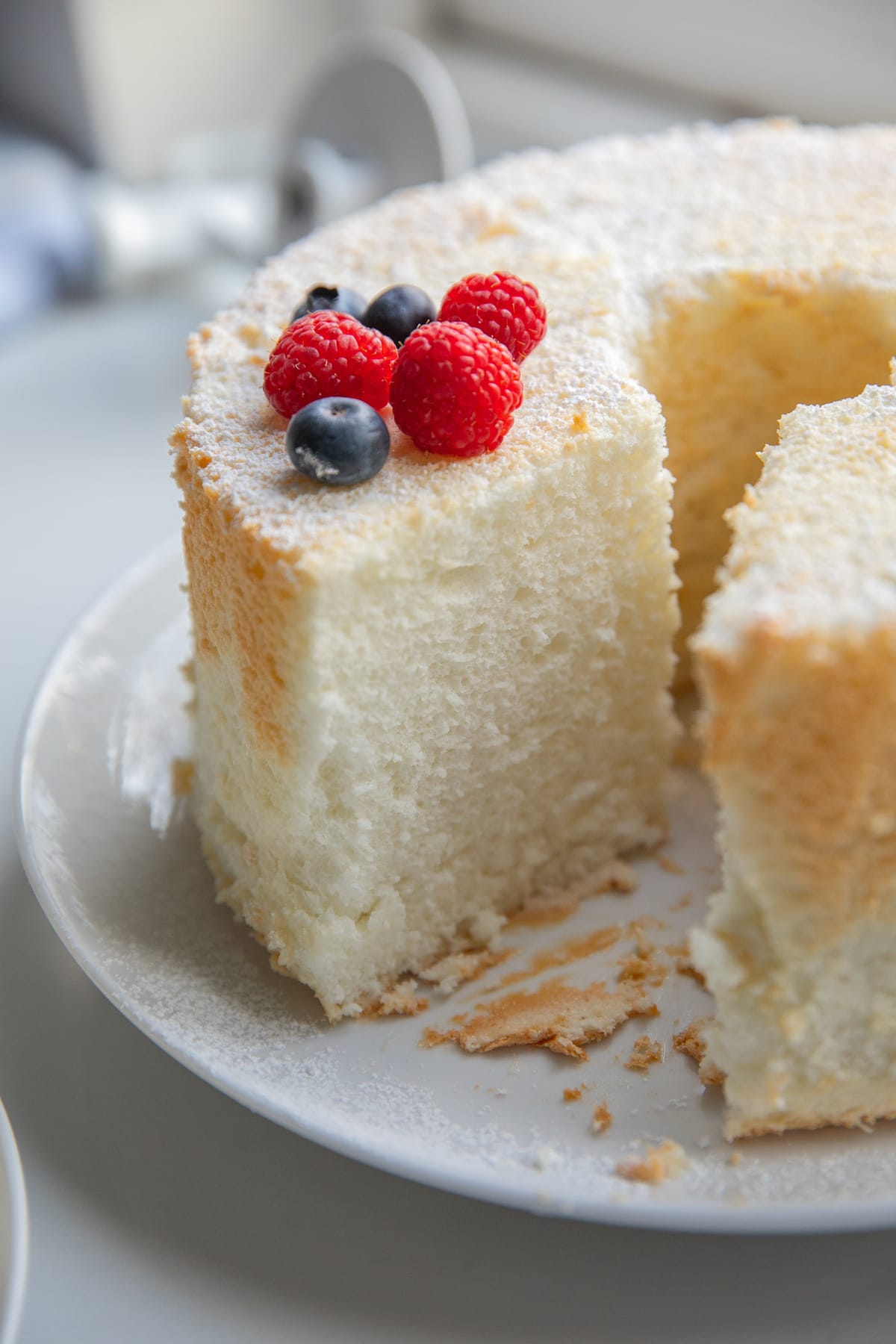whole angel food cake with fresh berries as garnish