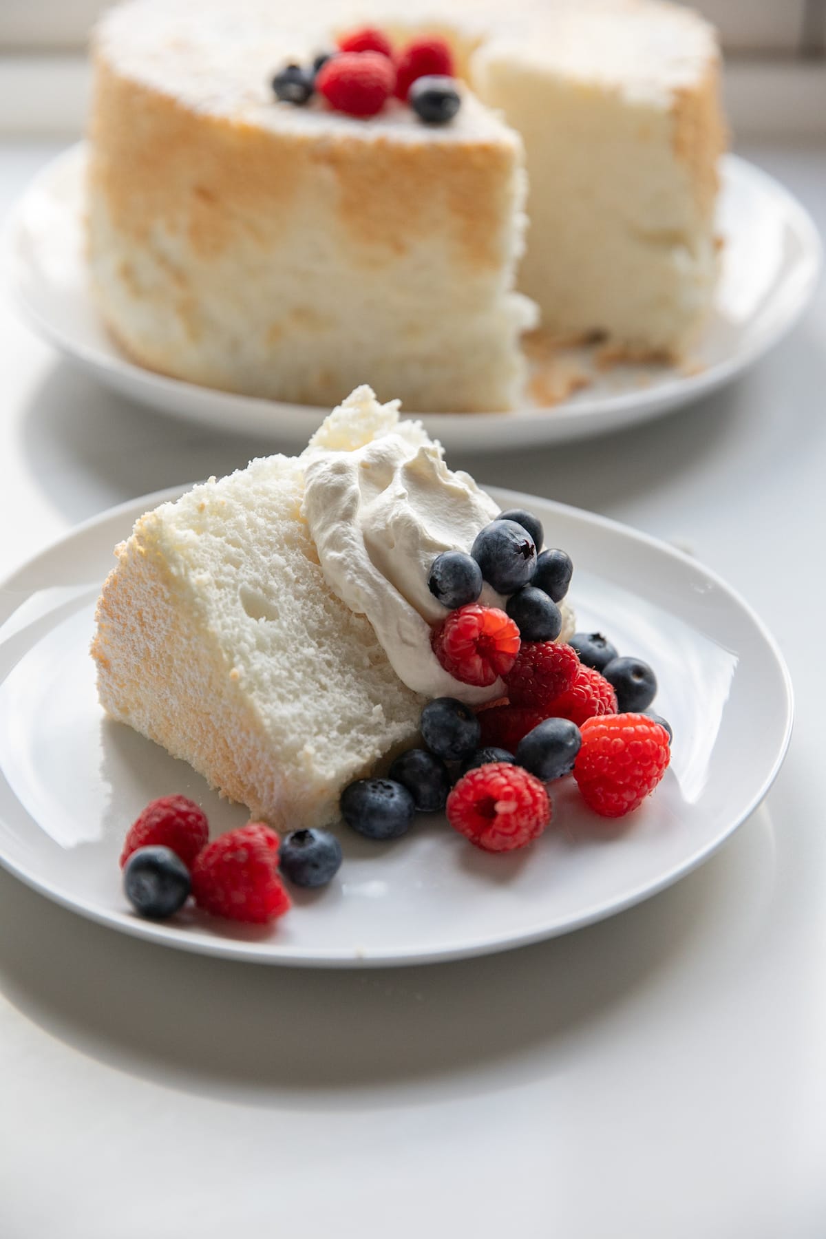 slice of angel food cake with whipped cream and berries