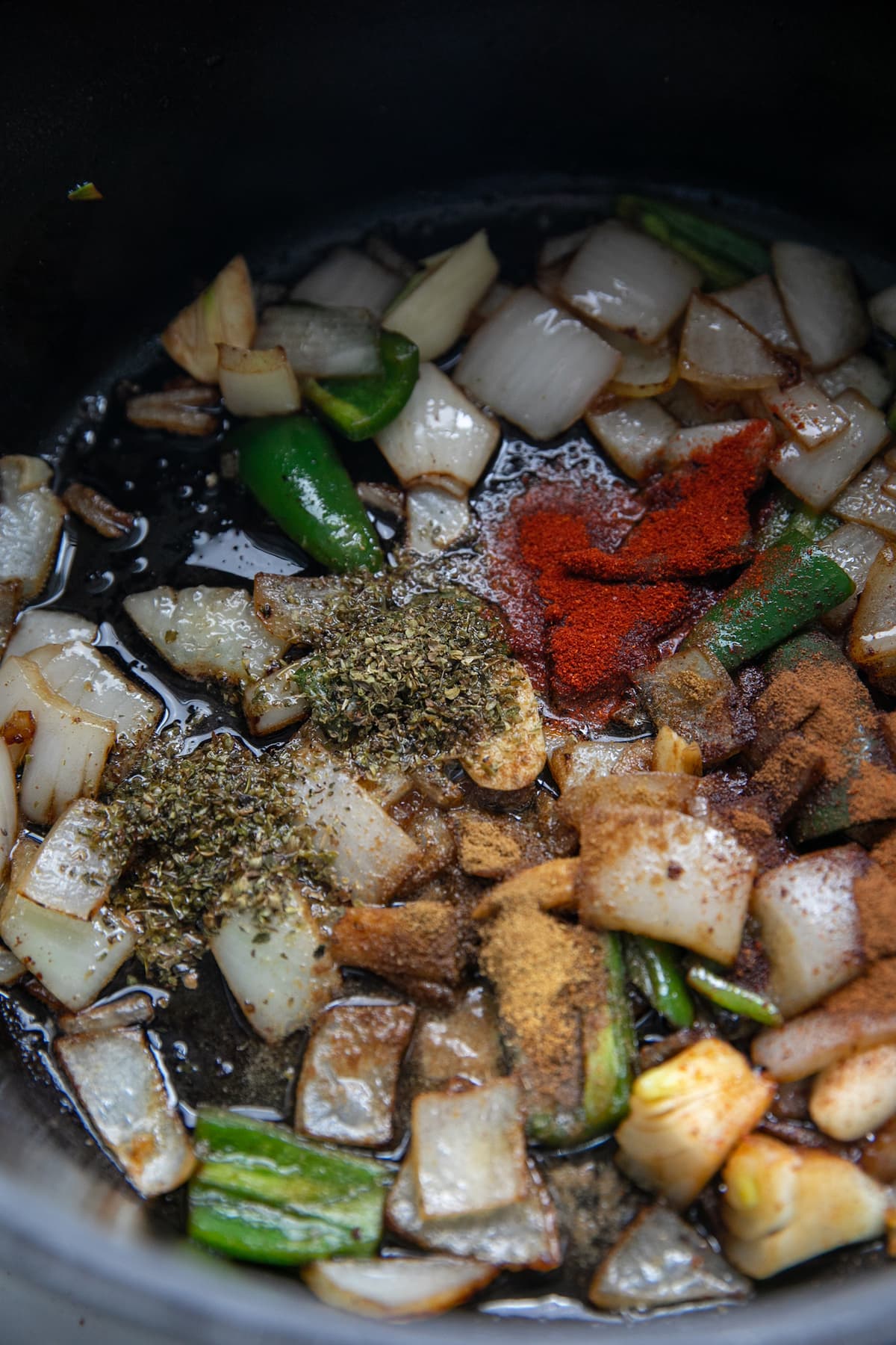 adding spices to onions and jalapenos