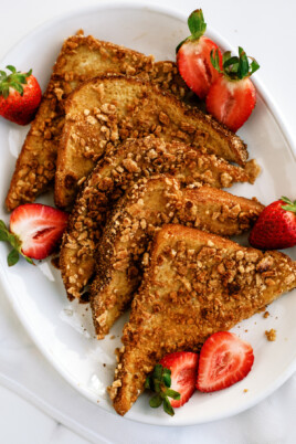 sliced Cinnamon Toast Crunch encrusted French toast with strawberries