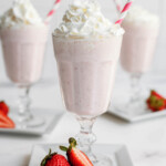 strawberry milkshake in glasses with straws