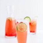 cherry limeade in a glass with lime slice