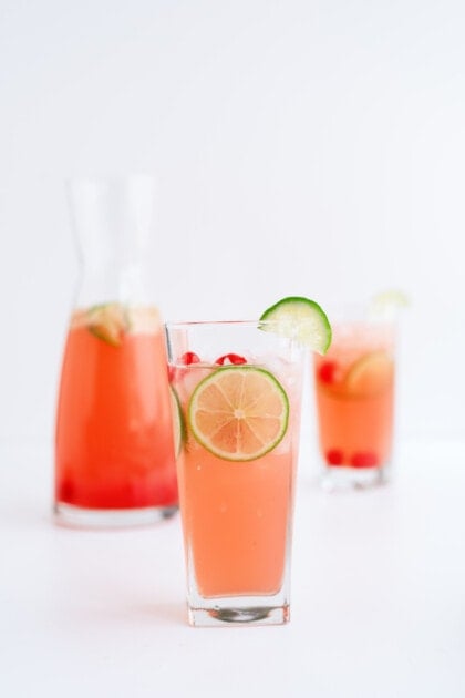 cherry limeade in a glass with lime slice