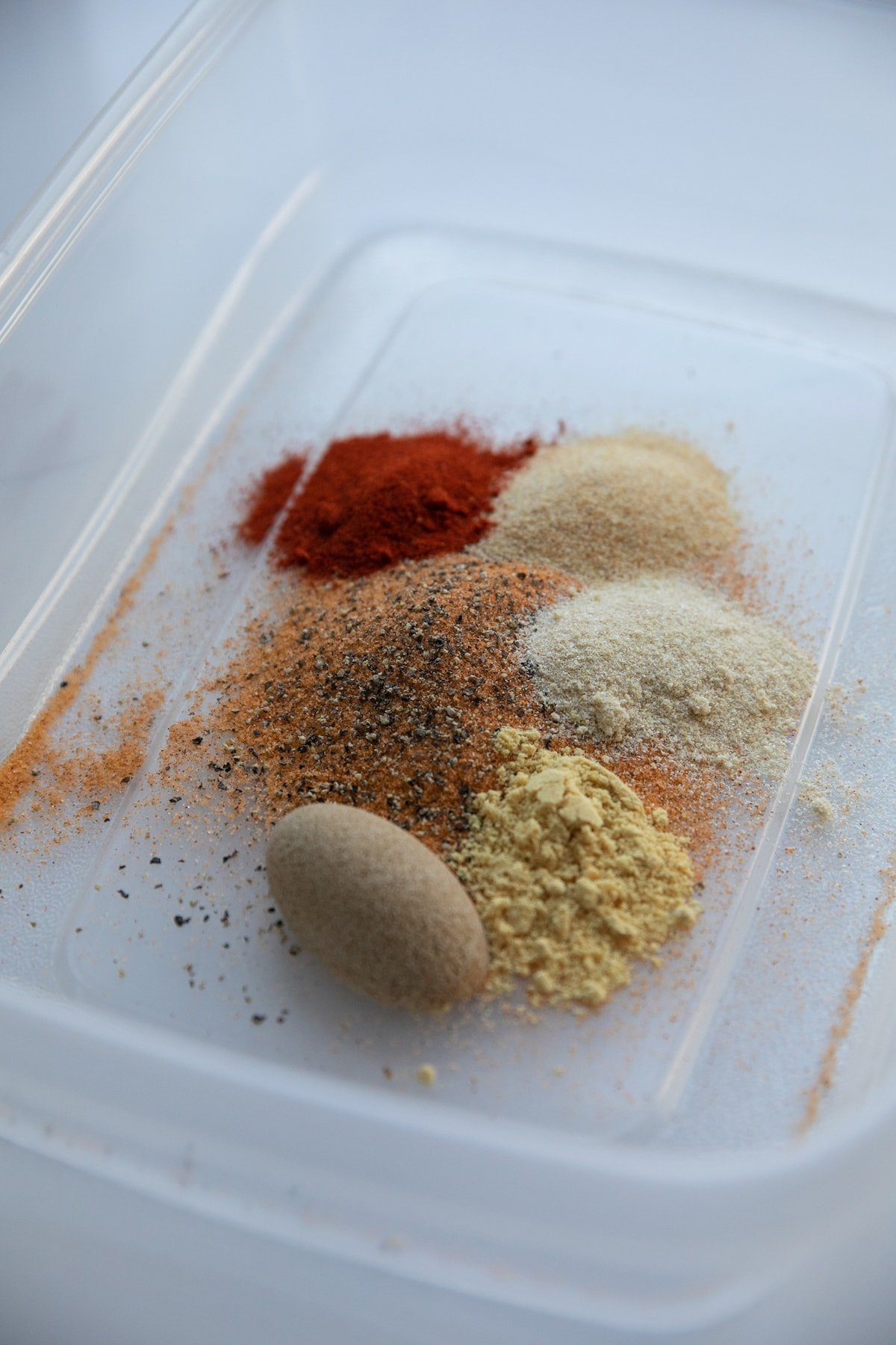 spices for chicken marinade in the bottom of a container