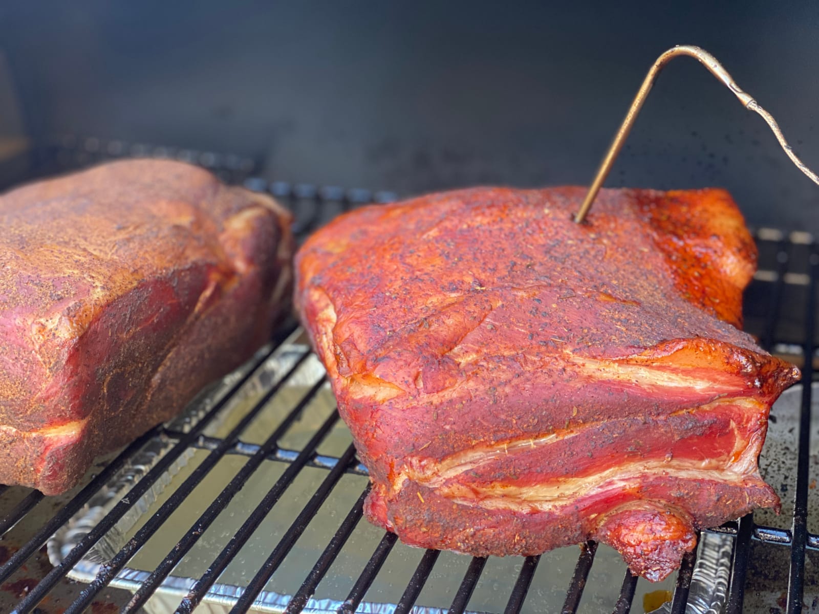 Raw Smoked Pork Butt on smoker with thermometer