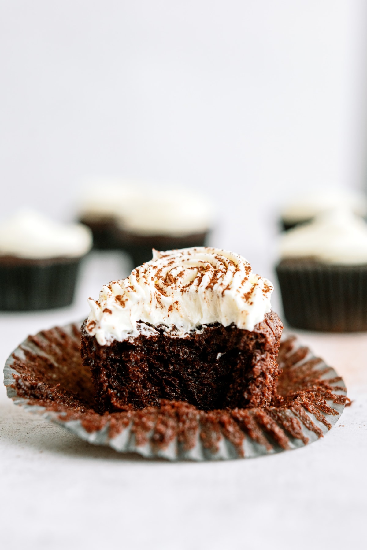 chocolate-cupcakes-with-vanilla-frosting with bite taken out
