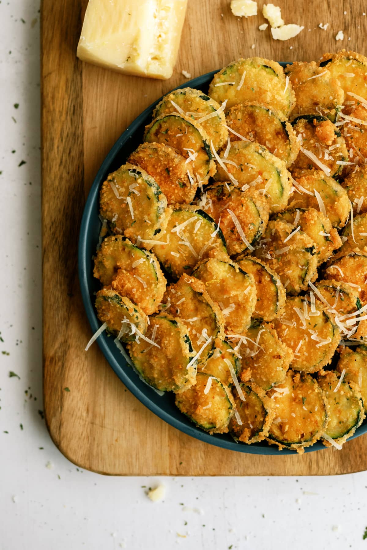 fried zucchini on green plate and cutting board