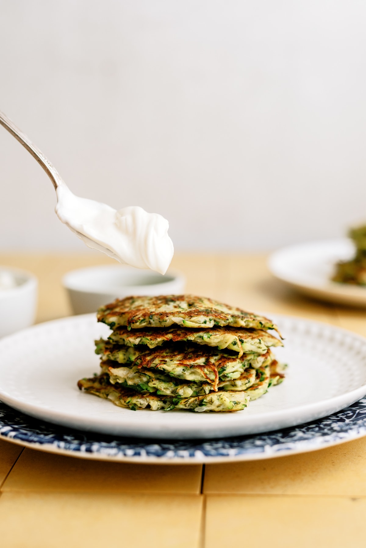 zucchini-fritters with dolloping sauce
