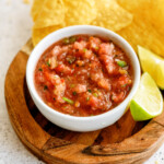 fresh-salsa with chips and lime on cutting board