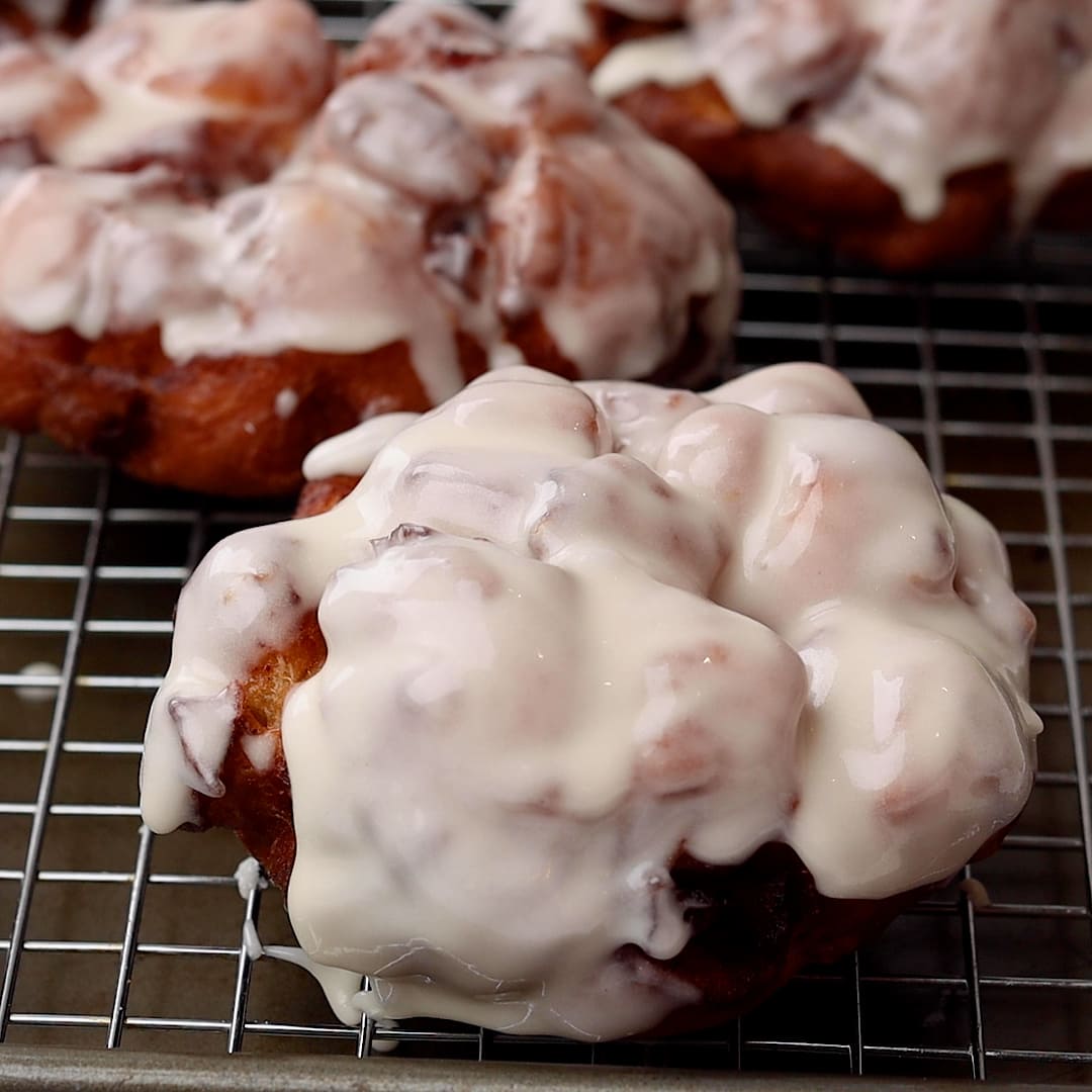 iced cooked Apple Fritters on cooling rack