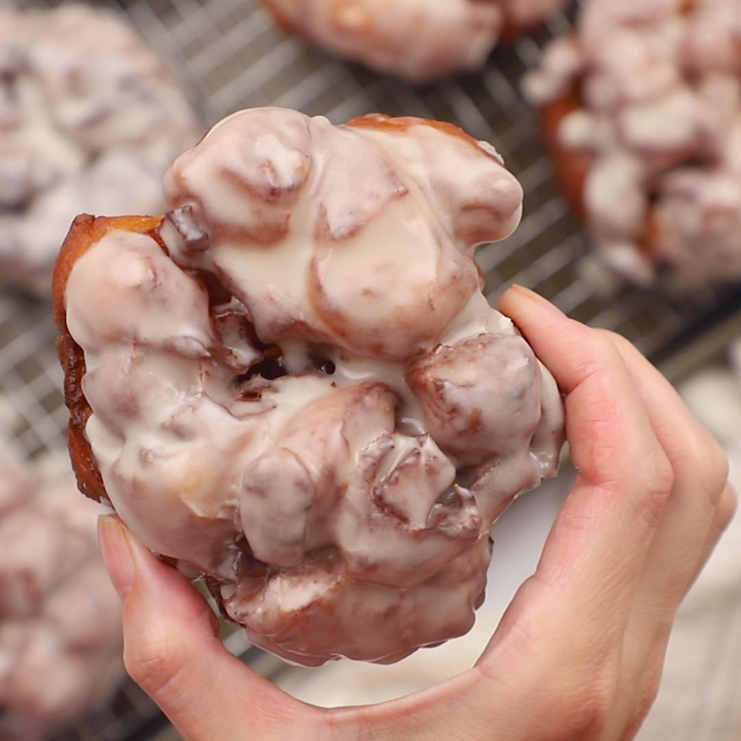 woman's hand holding iced Apple Fritters