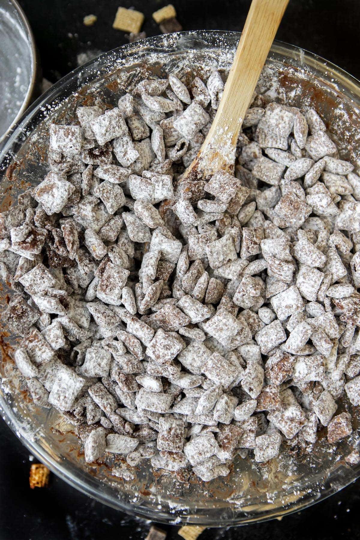 puppy chow with a wooden spoon in a big bowl