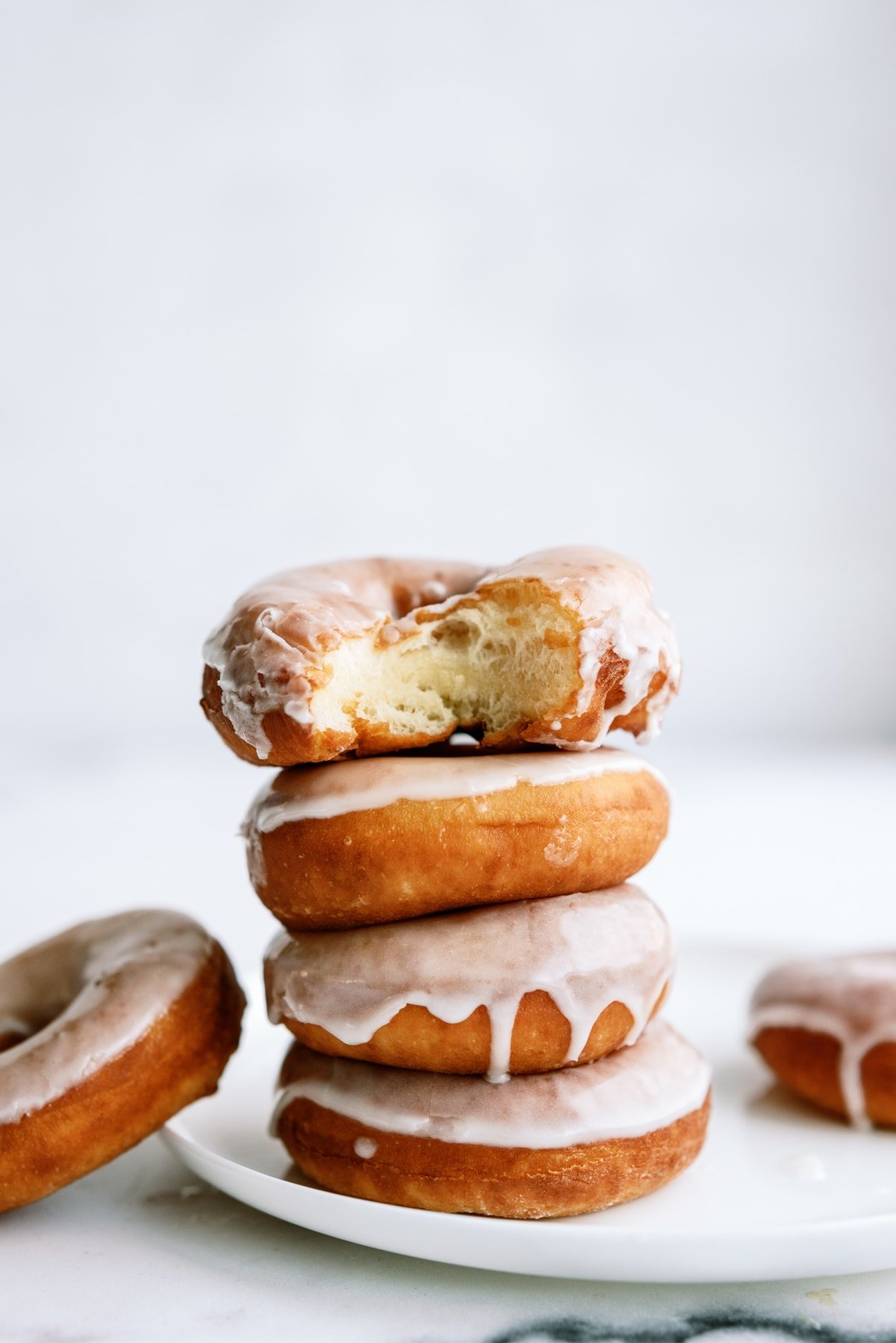 stack of glazed donuts on plate