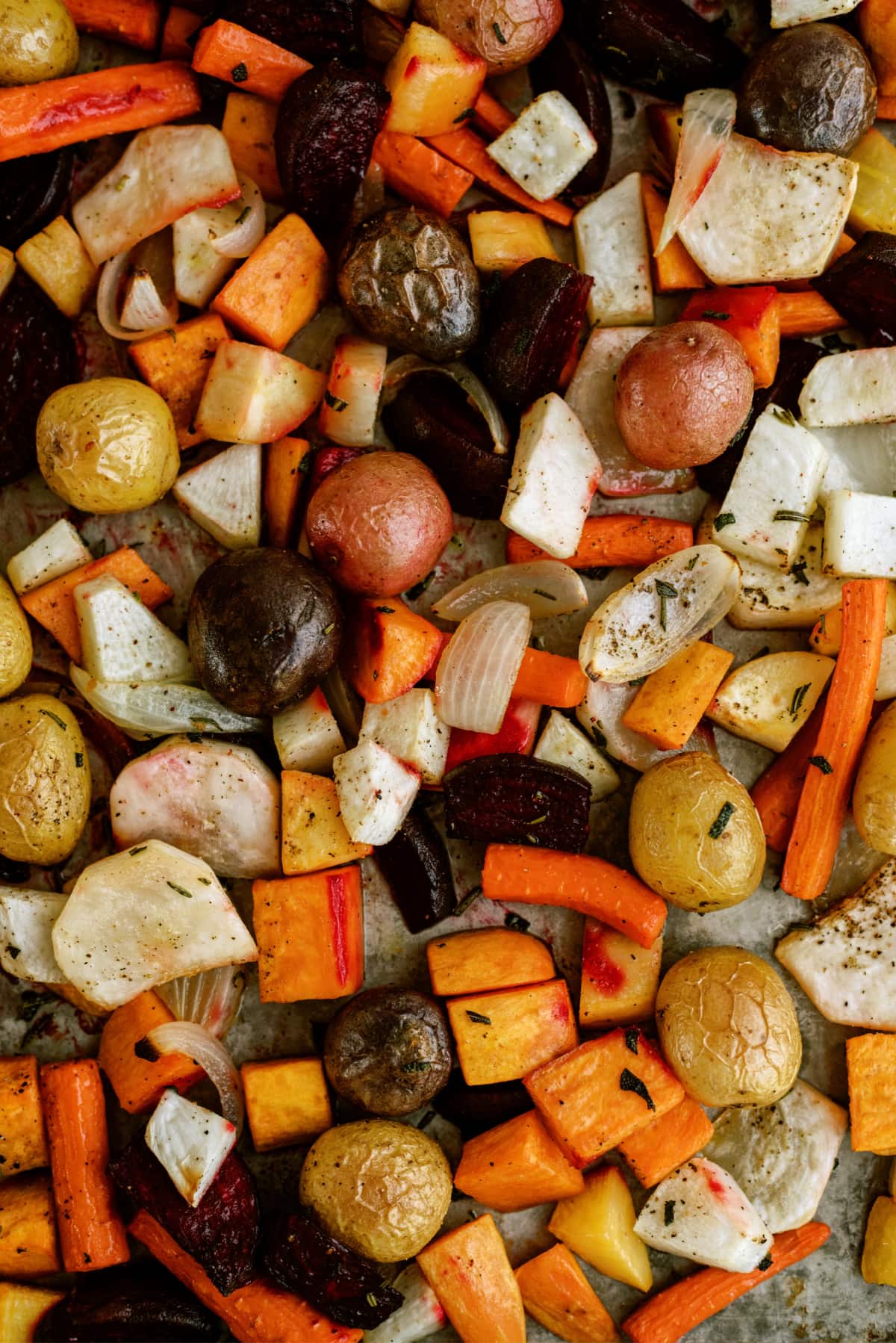 cooked roasted root vegetables on sheet pan