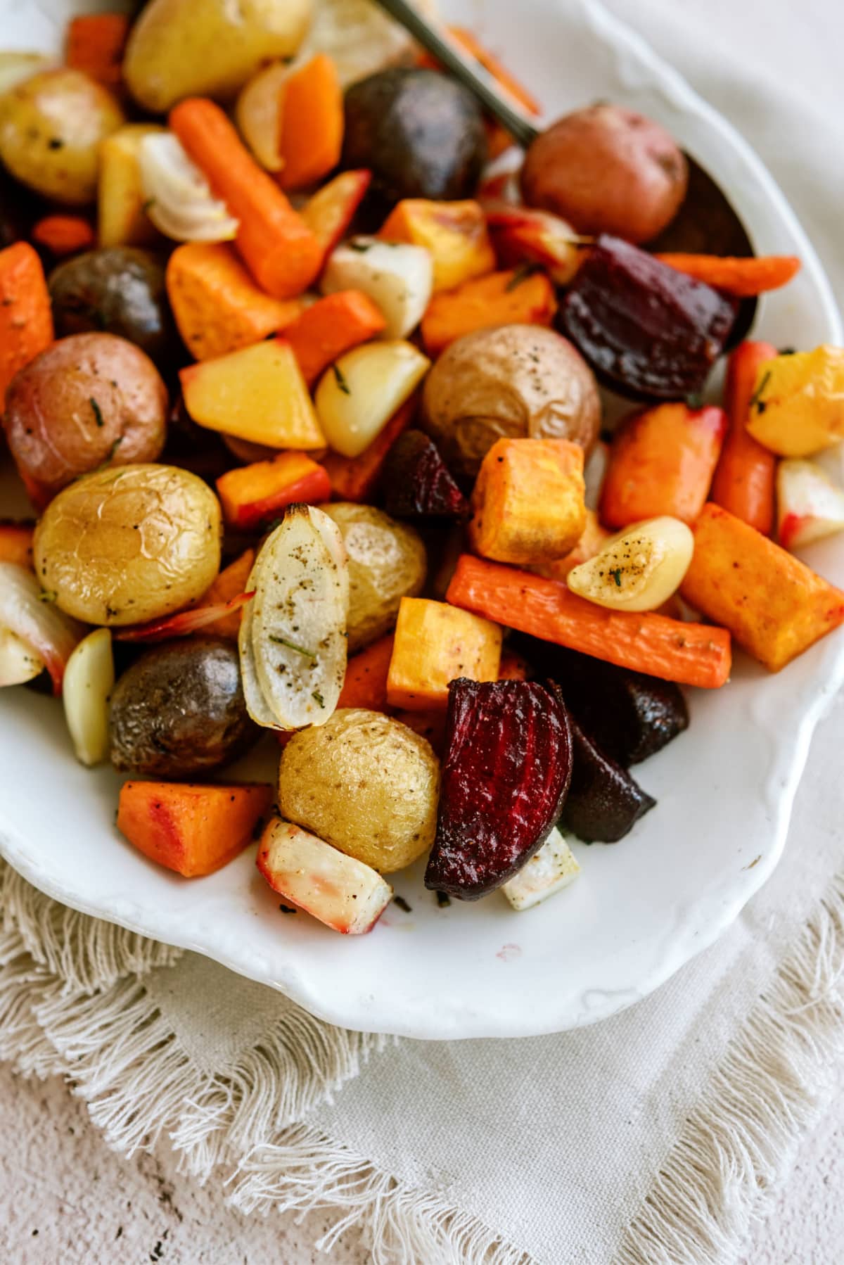 cooked roasted root vegetables on platter