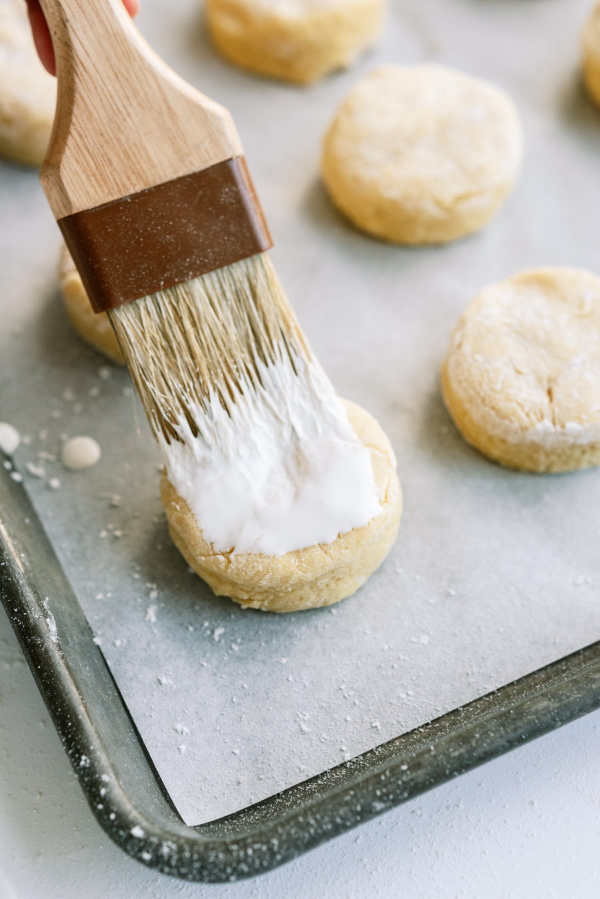 brushing strawberry-shortcake biscuits with cream