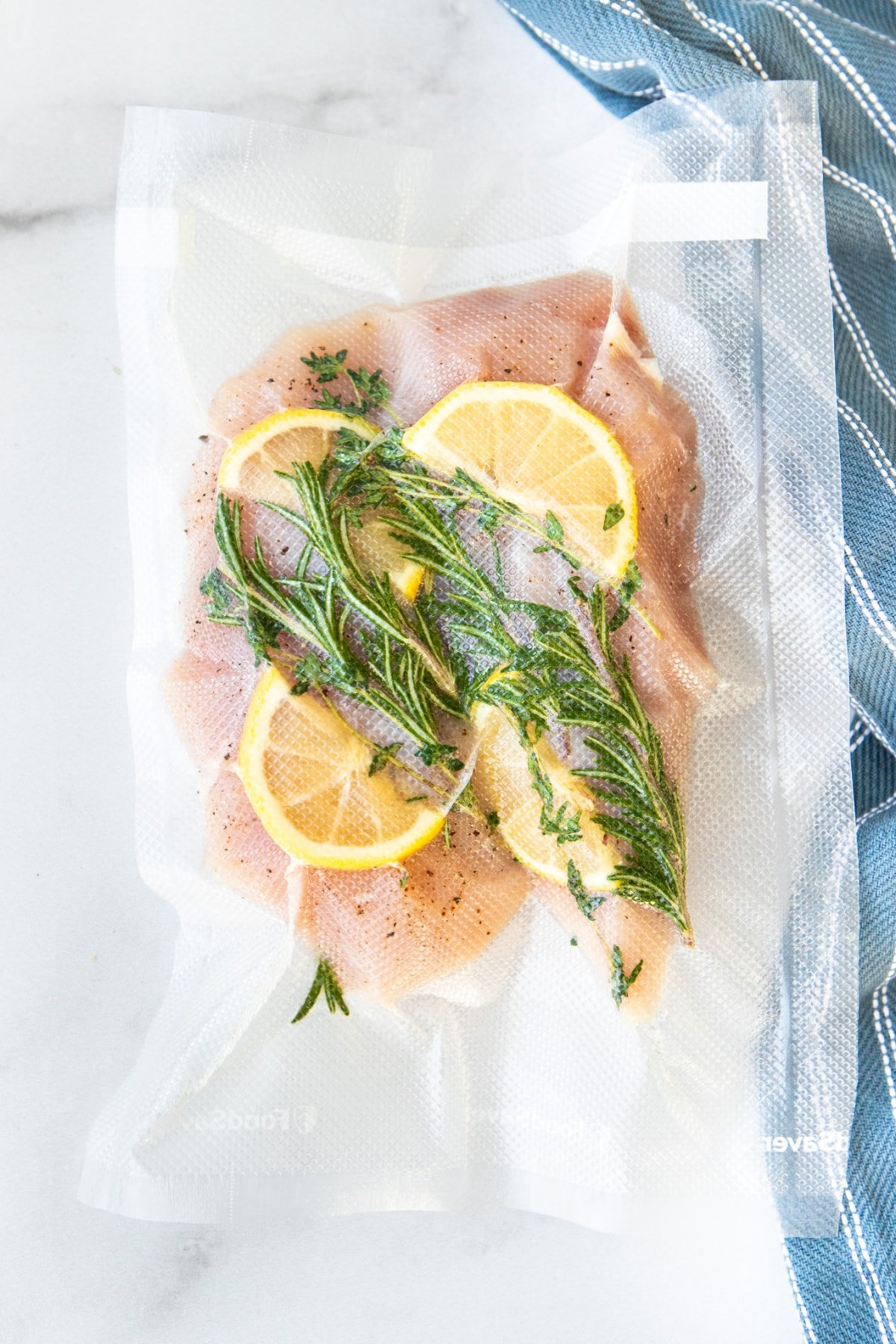 Chicken Breast in vacuumed sealed bag with herbs and lemon