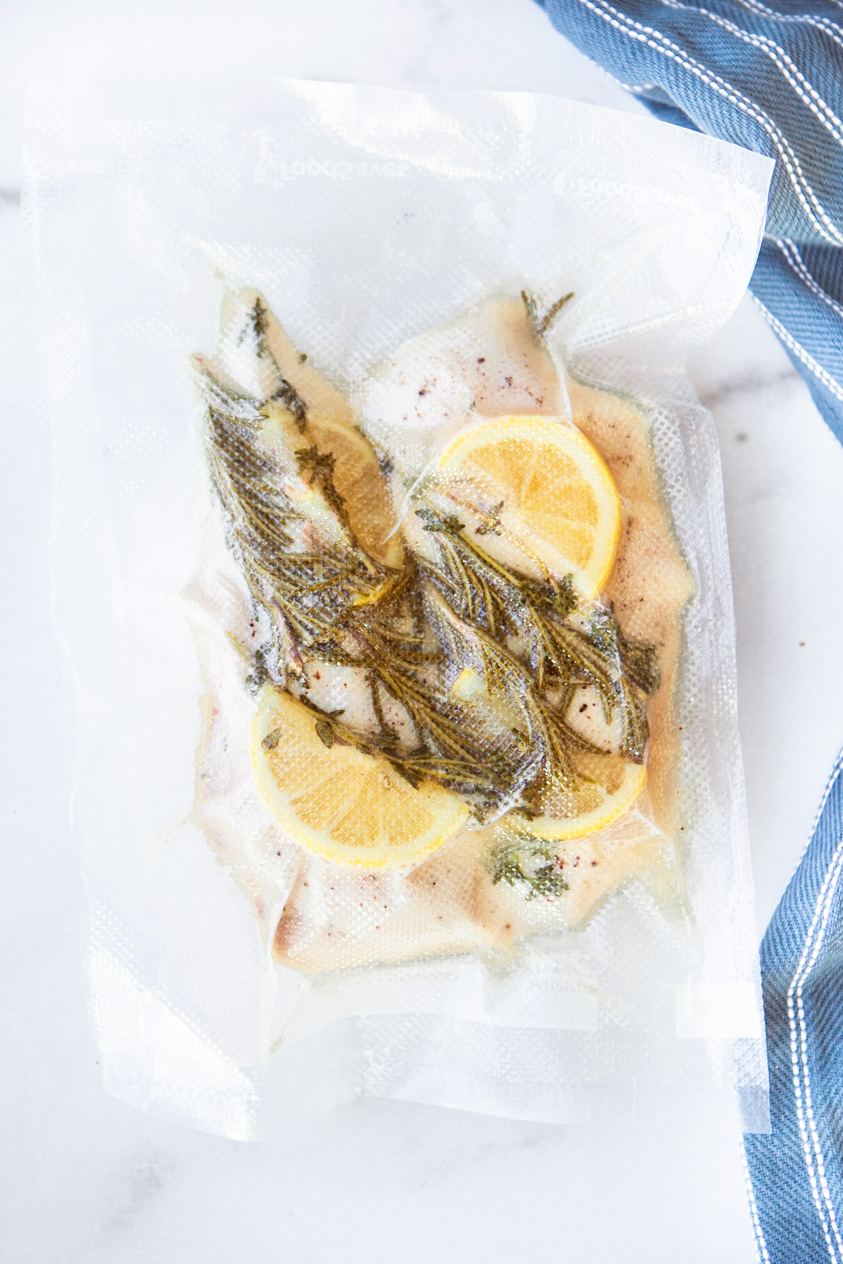 Chicken Breast in vacuumed sealed bag with lemons and herbs