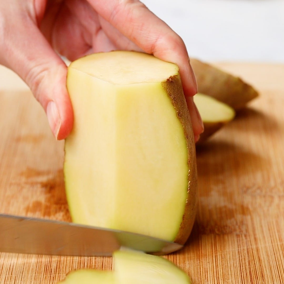 woman's hand peeling potatoes