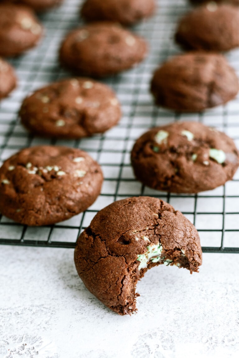 chocolate-mint-cookies with bite taken out on cooling rack