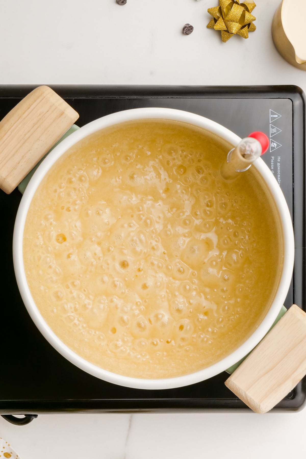 boiling butter, sugar, marshmallow and evaporated milk in a pot.  
