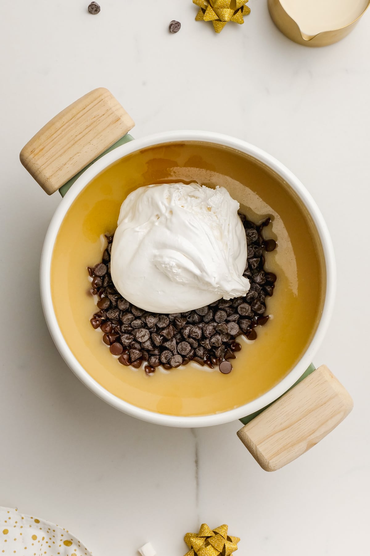 evaporated milk, butter, chocolate cups and marshmallow creme in a pot