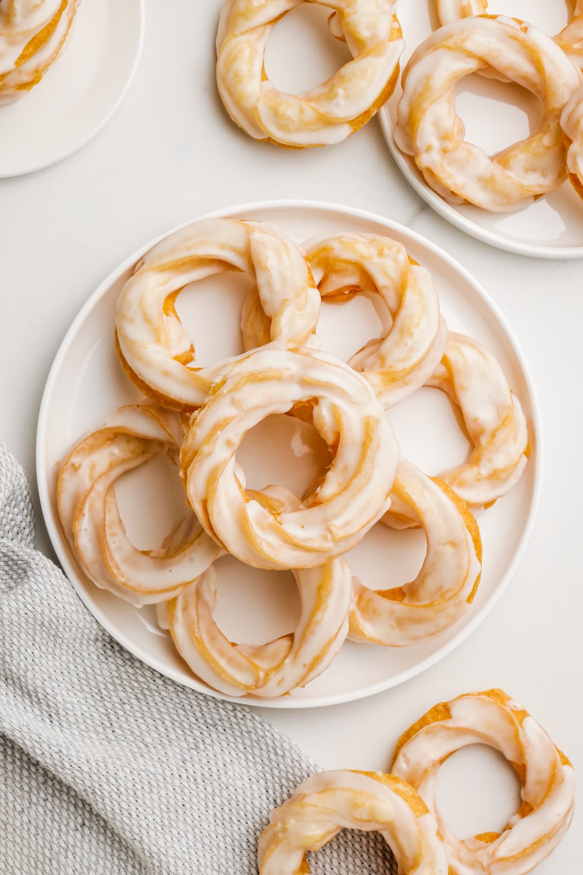 pile of french crullers on plate