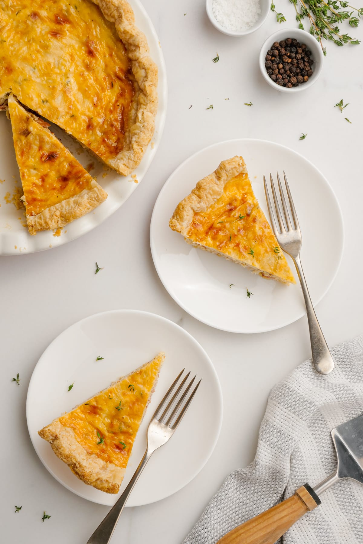 quiche lorraine pieces on plates with forks