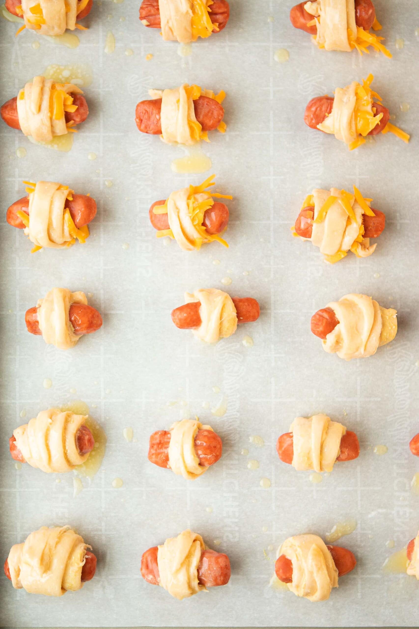 unbaked pigs in a blanket on baking sheet