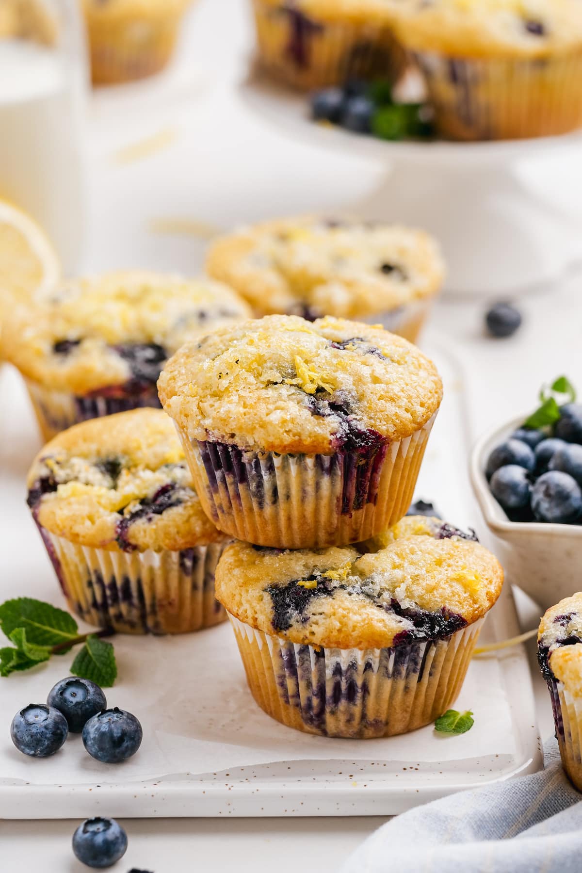 stacked baked blueberry muffins on cutting board