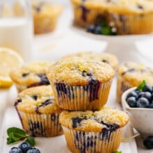 stacked baked blueberry muffins on cutting board