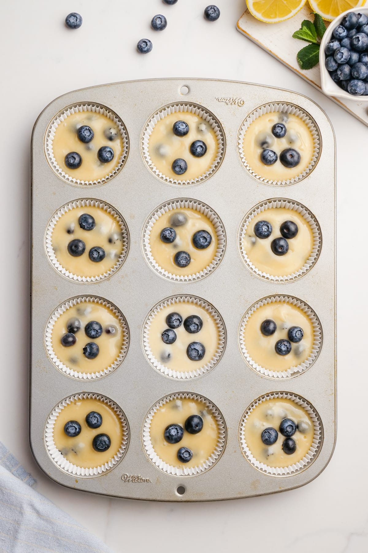 blueberry-muffins batter into cupcake pan