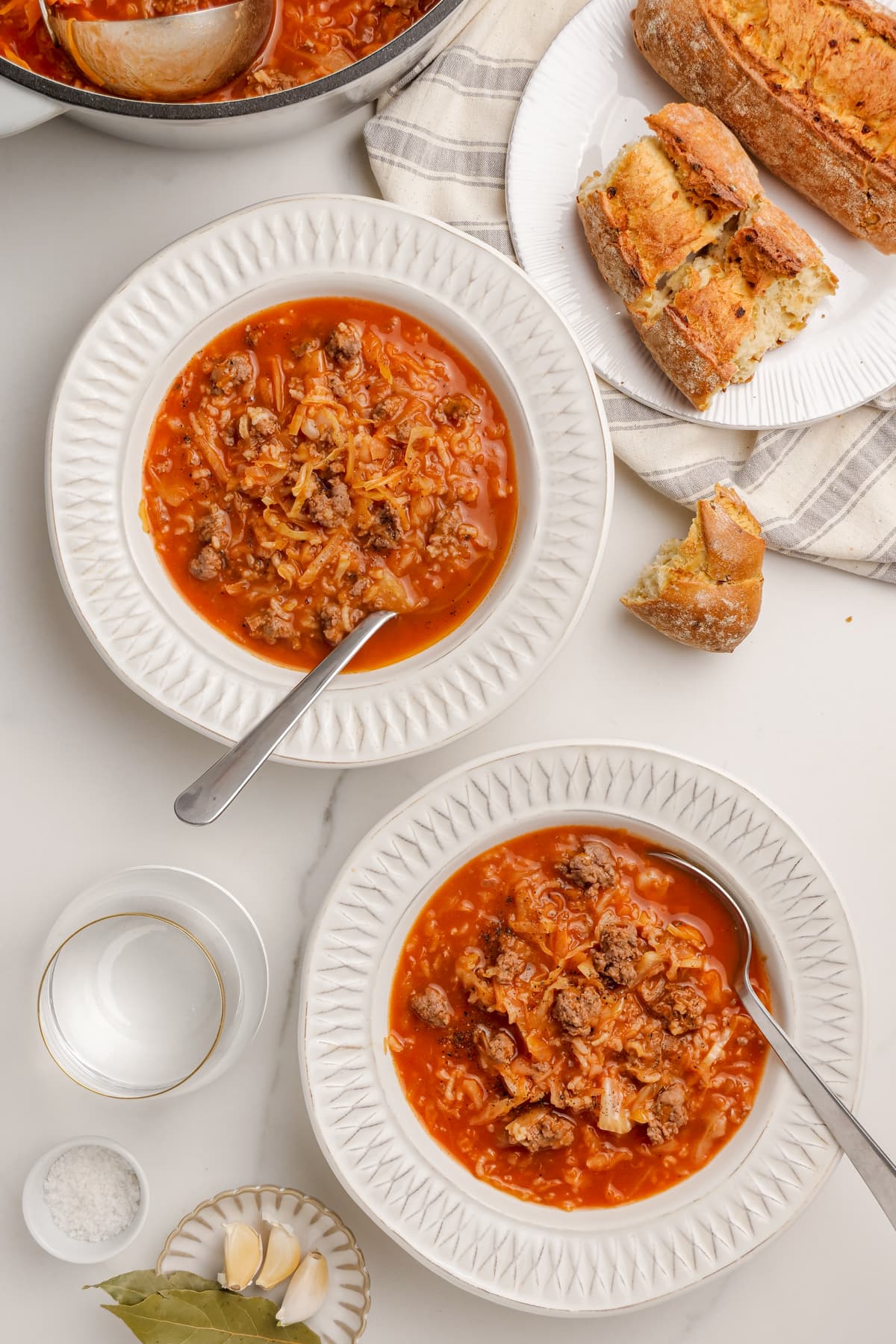 Stuffed cabbage soup in serving bowls with spoons