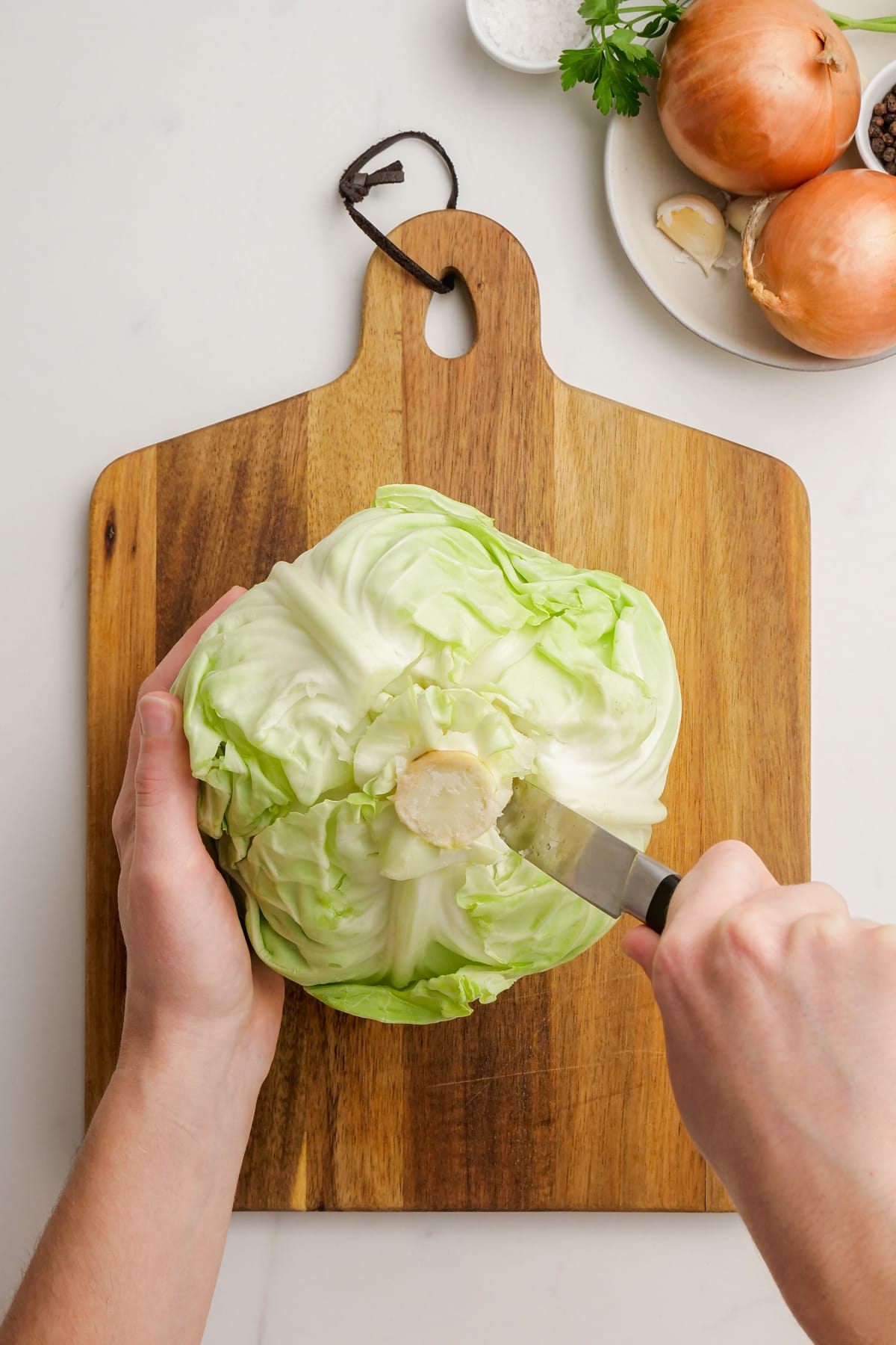 woman cutting core out of cabbage