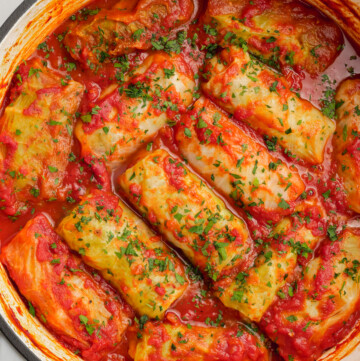 cooked cabbage rolls in dutch oven with fresh parsley