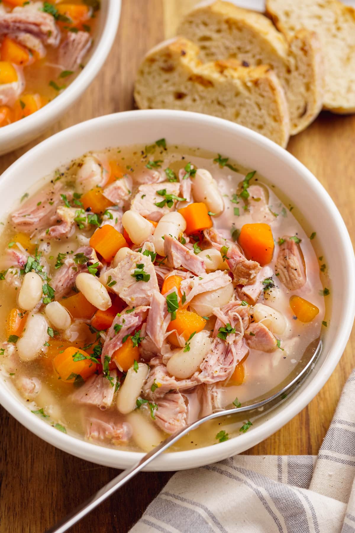 ham and bean soup in bowl with spoon