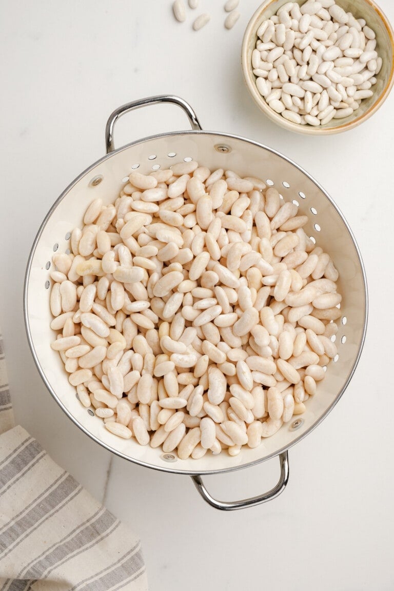 soaked and drained navy beans in a collander