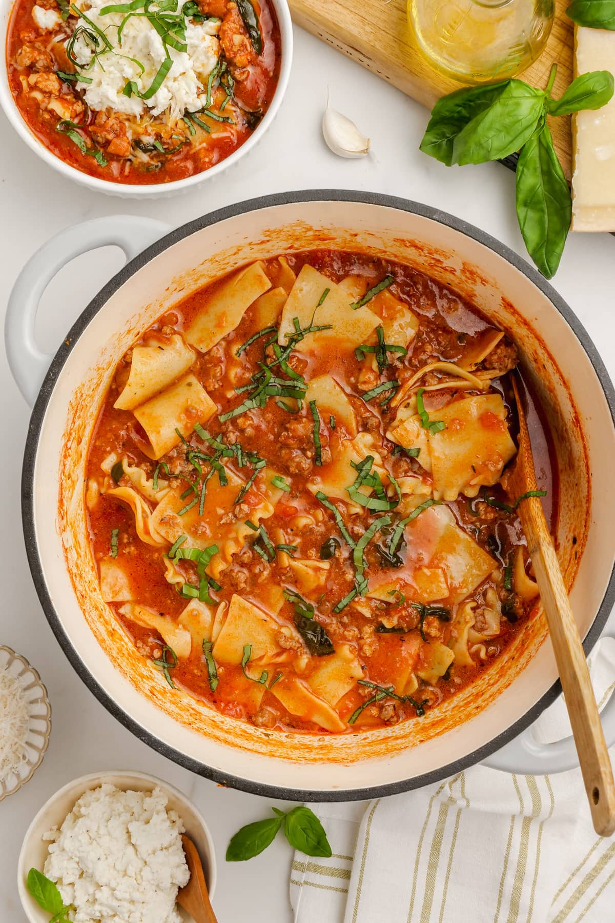 lasagna soup in pot with wooden spoon on tablescape