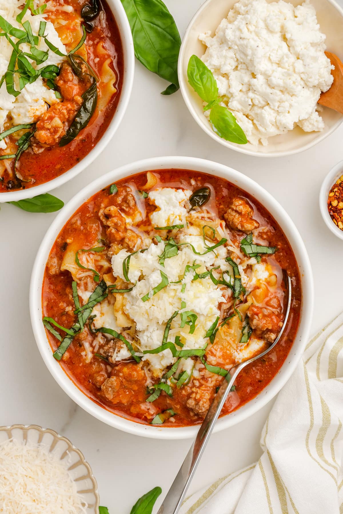 lasagna soup in bowl with spoon on tablescape