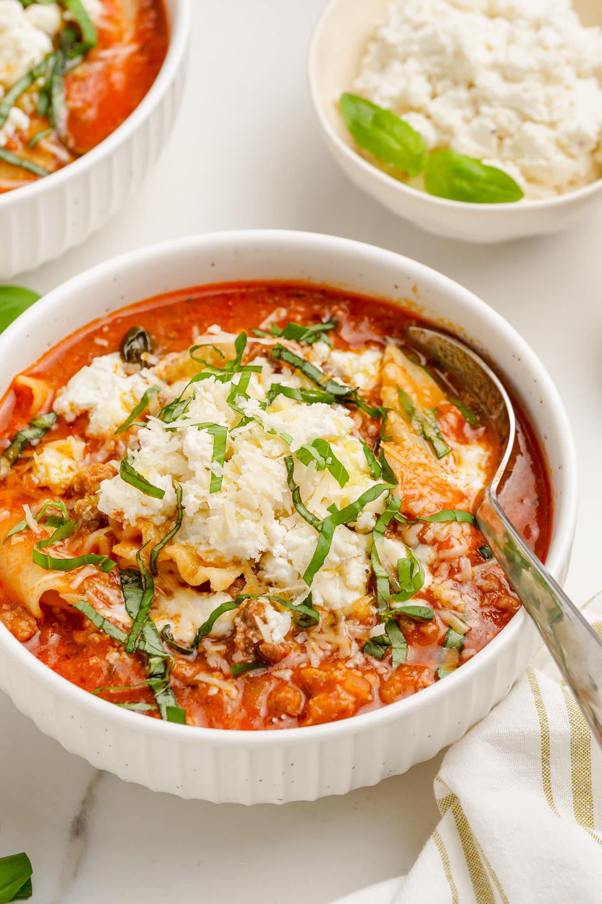 lasagna soup in bowl with spoon on tablescape