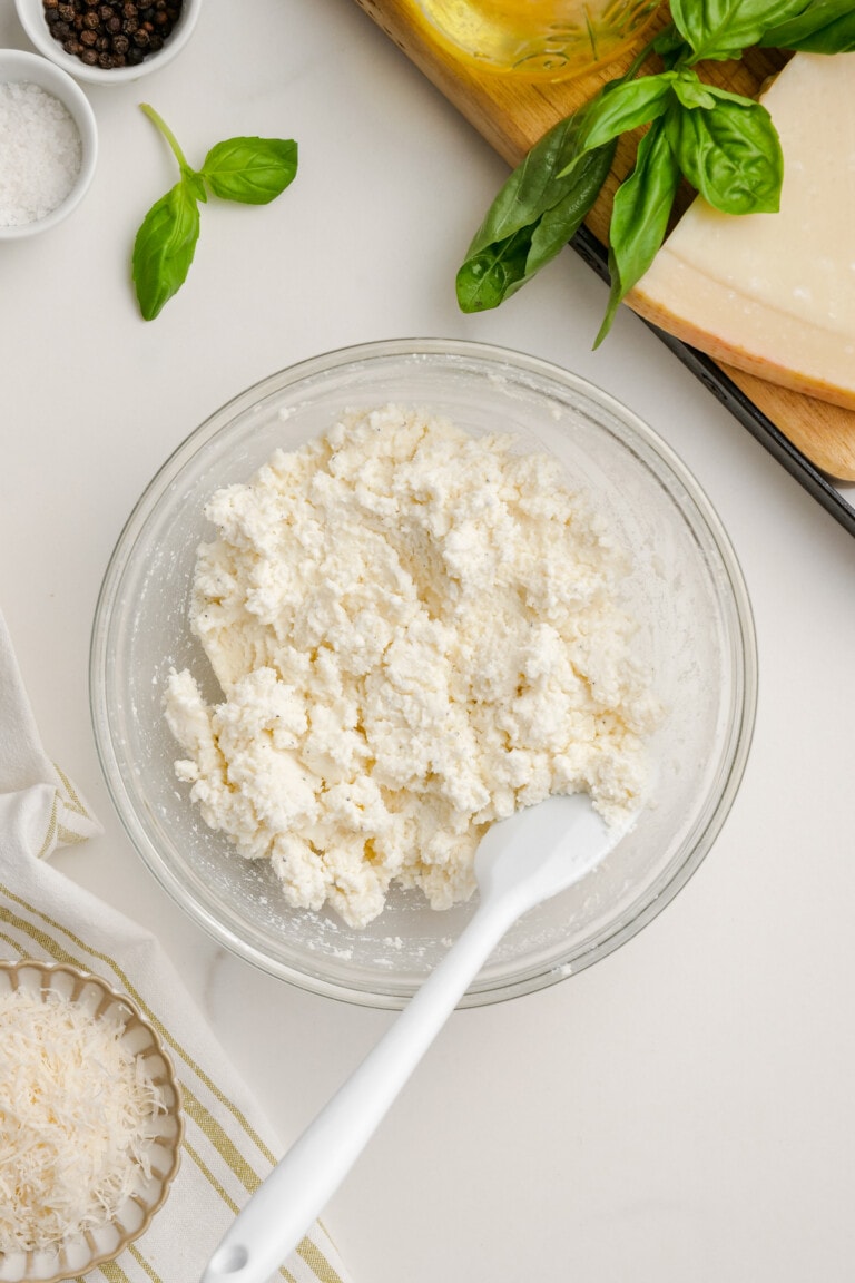 ricotta cheese in bowl with plastic spoon