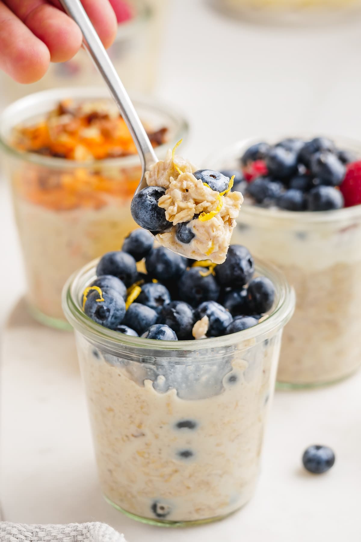 spooning out overnight oats from jar