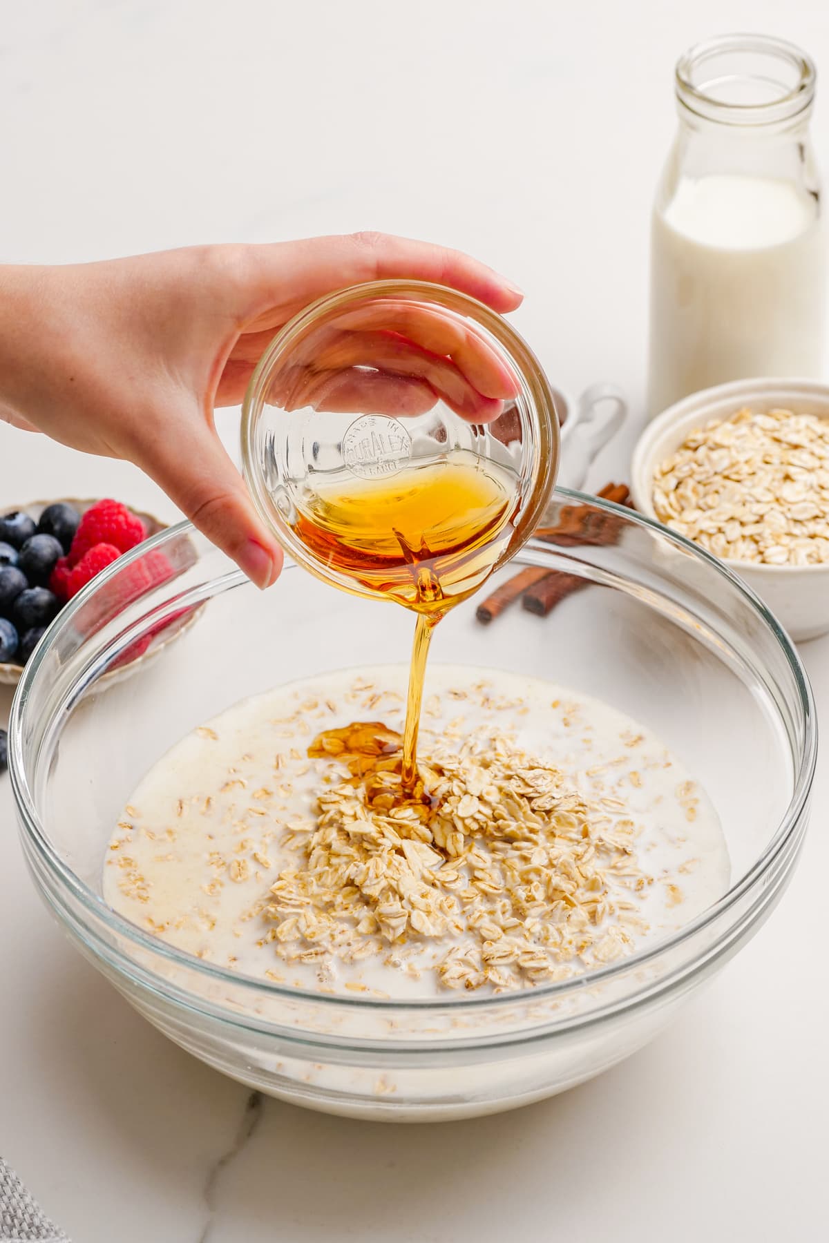 pouring syrup into bowl of oats
