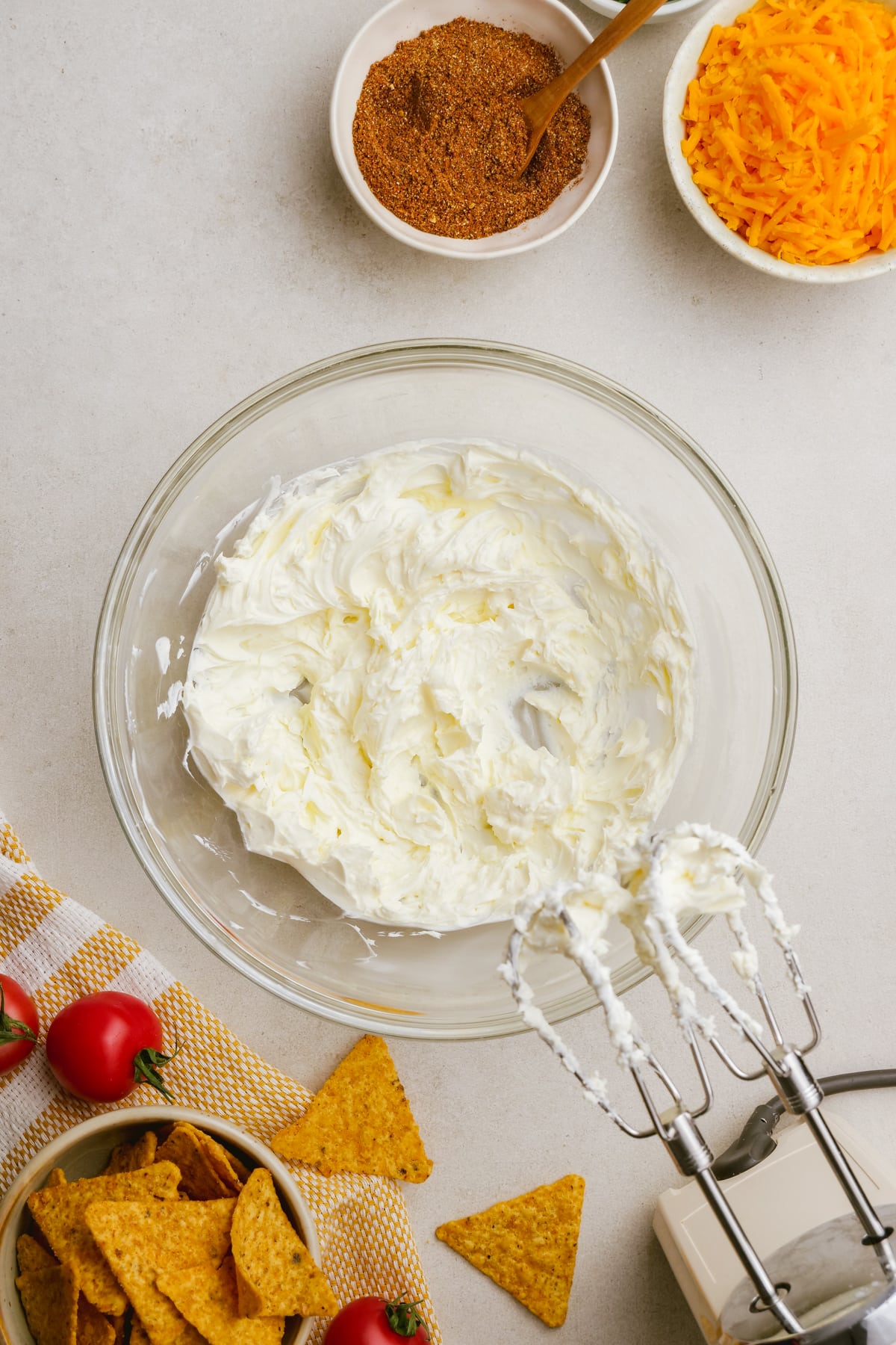 cream cheese in bowl with hand mixer